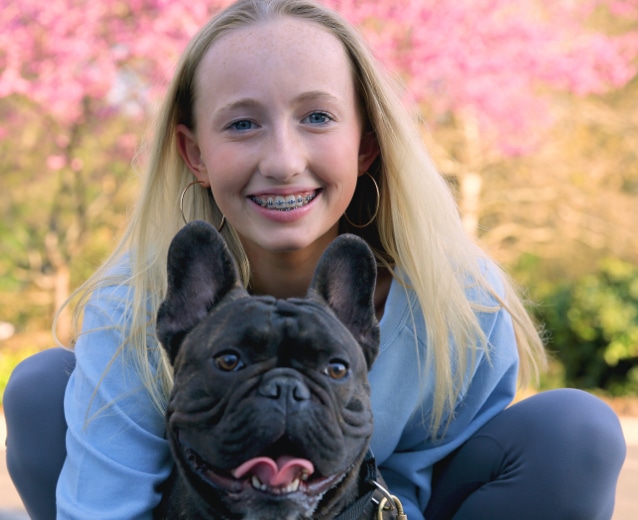 Girl and her dog Dr. W. Gray Grieve Orthodontics in Eugene, OR