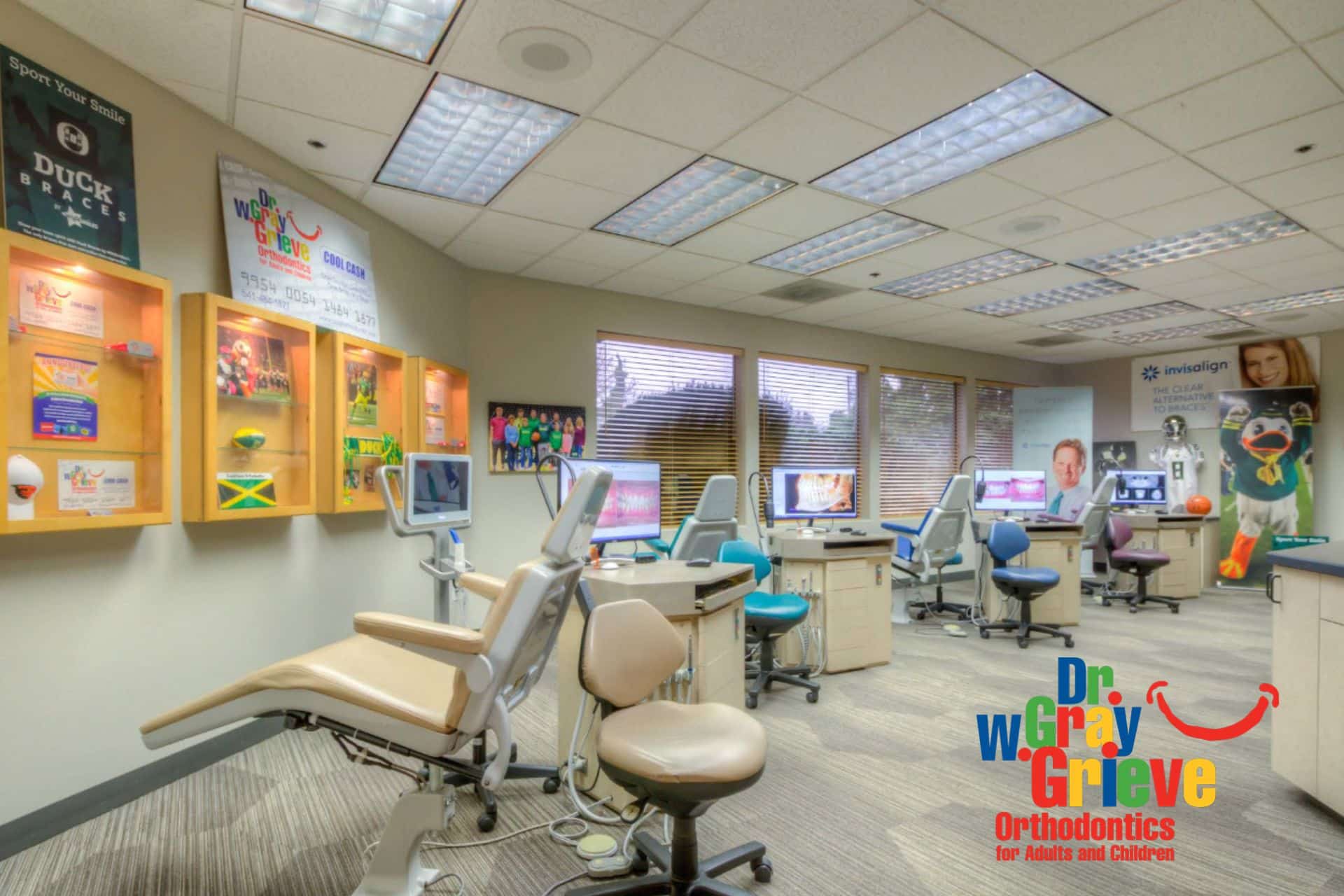 Bright orthodontic treatment room with dental chairs, computer monitors, and large windows, Dr. W. Gray Grieve Orthodontics, Eugene, OR