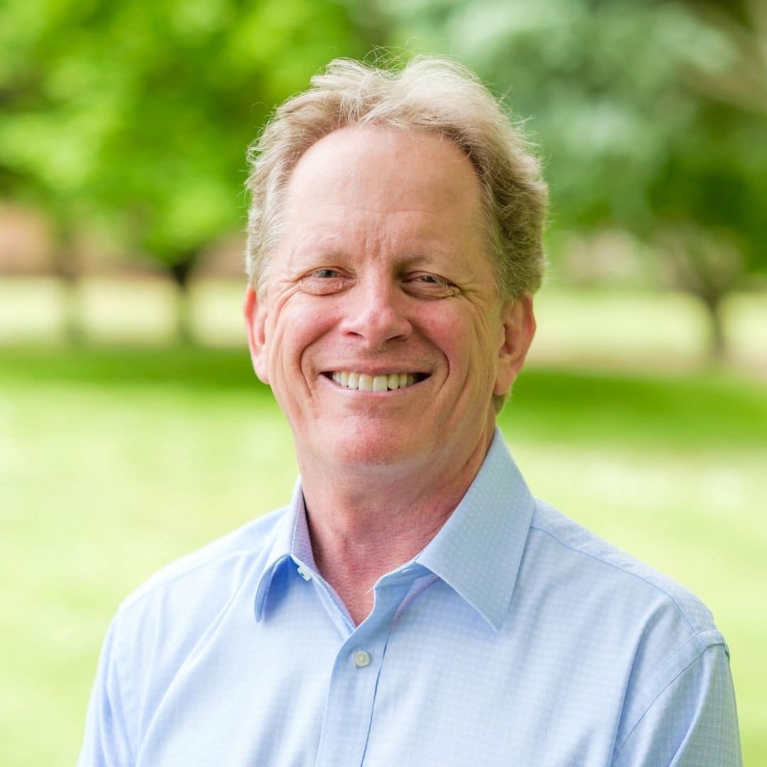 Portrait of Dr. Gray Grieve smiling outdoors with trees in the background, Dr. W. Gray Grieve Orthodontics, Eugene, OR