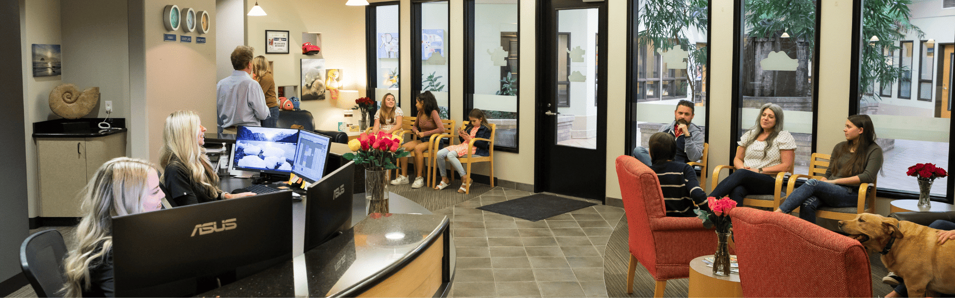 Orthodontic office reception and waiting area with front desk, seating, staff, and families during a clinic visit, Dr. W. Gray Grieve Orthodontics, Eugene, OR